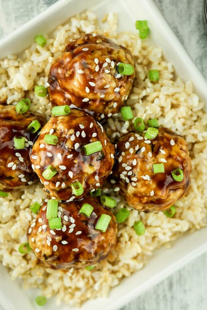 Chicken Teriyaki Meatballs over brown rice with green onions.