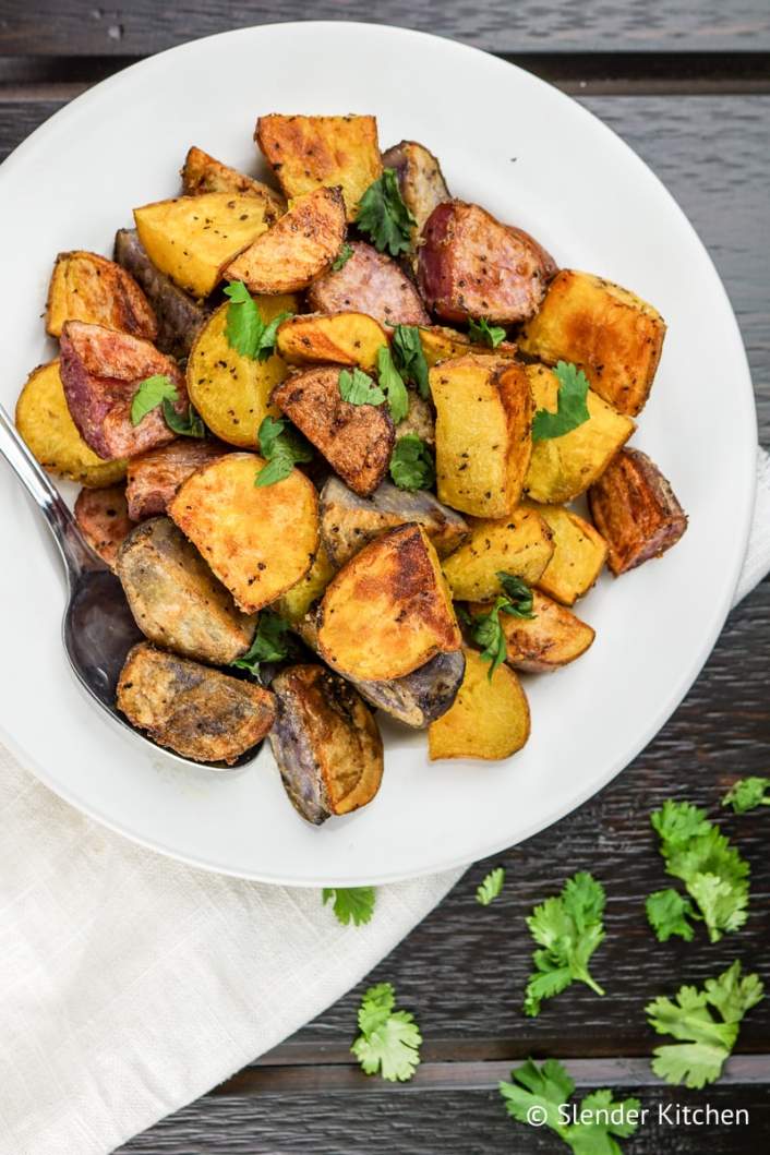 Easy Roasted Potatoes on a serving dish with fresh parsley.