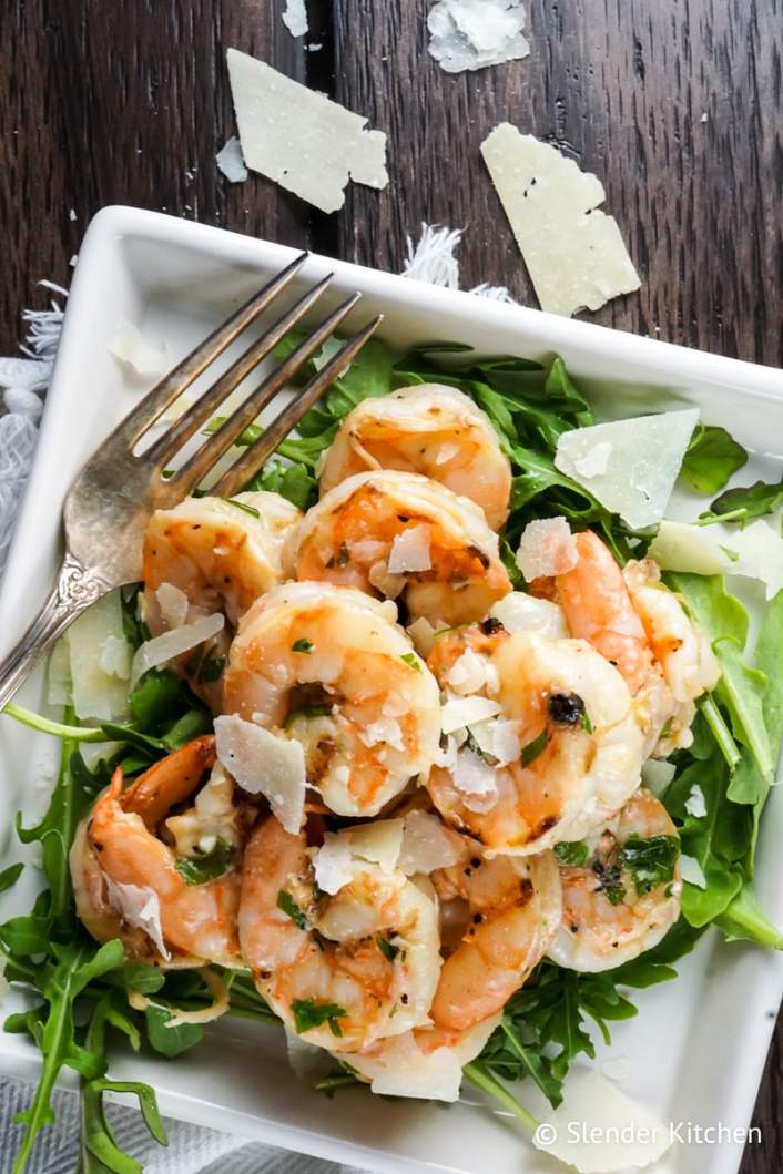 Garlic Parmesan Shrimp fresh out of the oven over a bed of greens.