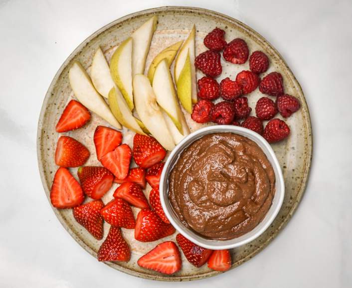 Brownie Batter Chocolate Hummus with strawberries and raspberries.