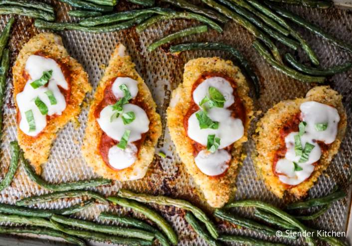 Chicken parm and green beans on a sheet pan.