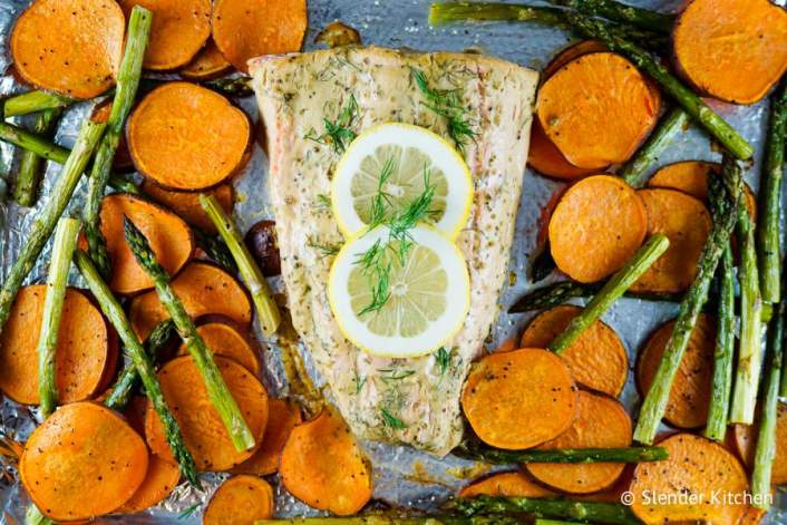 Salmon, sweet potatoes, and asparagus cooked together for a healthy sheet pan dinner.