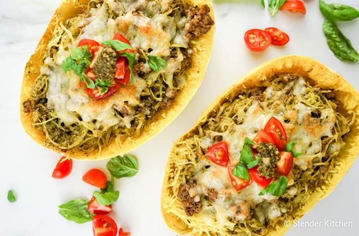 Low Carb Pesto Spaghetti Squash in the shell with cheese on top.